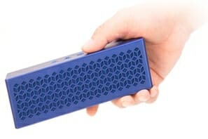 a hand holding a blue speaker