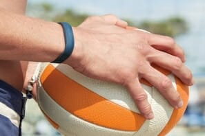 a close-up of a person holding a volleyball