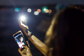 a person holding a phone with a light in their hand