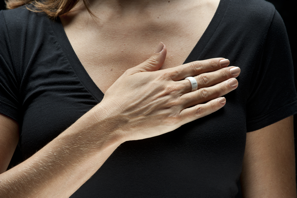 a woman with her hand on her chest