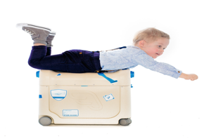 a child on top of a suitcase