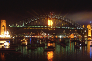 a bridge over water with boats in the water