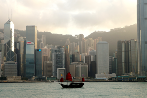 a boat in the water with a city in the background