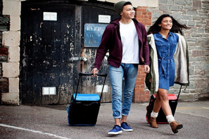 a man and woman walking with luggage