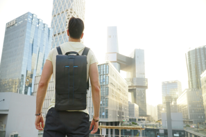 a man with a backpack looking at a city