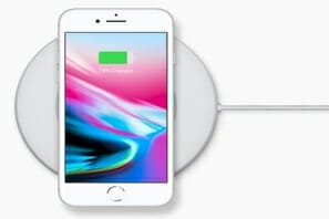 a white phone on a wireless charger