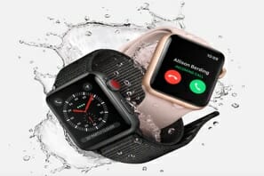a couple of smart watches in water