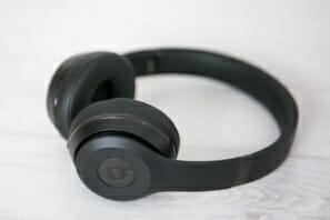 a black headphones on a white surface