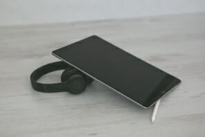 a black tablet with a stylus on a white surface