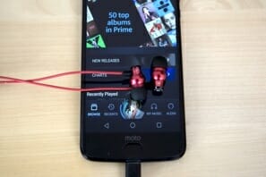 a phone with a red headphone plugged into it