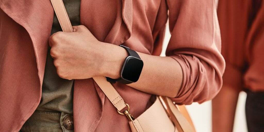 fitbit versa 2 in black being worn by female. {Tech} for Travel. https://techfortravel.wpengine.com
