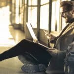 TripIt Improves Android App (v.9.0.1) Man travelling using smartphone and laptop