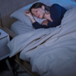 Get a Better Nights Sleep on your Next Hotel Stay with the New Bose Sleepbuds 2 a woman sleeping in bed