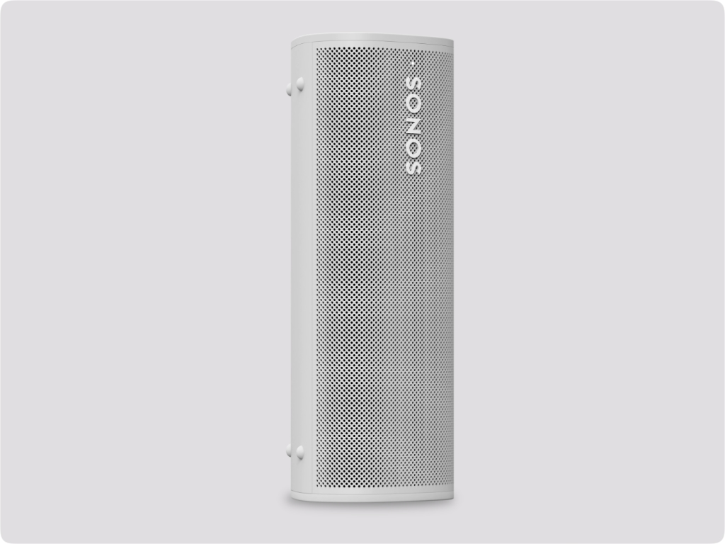 a white speaker with holes