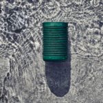 Indoor Sounds Made for the Great Outdoors with the New B&O Beosound Explore Portable Speaker a green can on the water