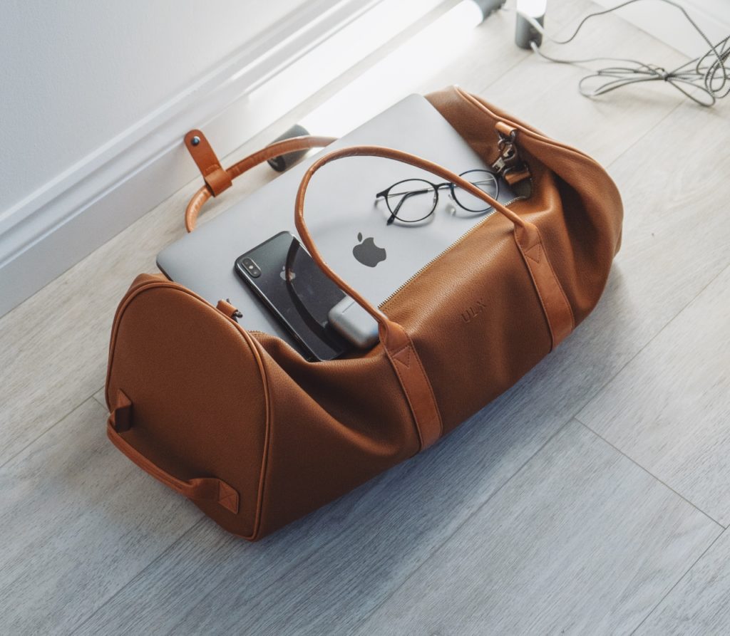 a bag with a laptop and glasses on it