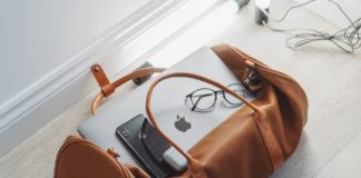 The Best 14 Must-Have Travel Gadgets for 2021 a bag with a laptop and glasses on it