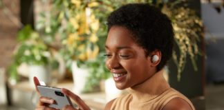 Sony Improves on Perfection with the New WF-1000XM4 Wireless Headphones a woman holding a phone