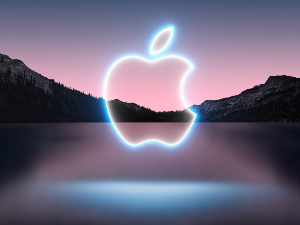 a logo of an apple with a mountain in the background