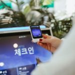 Pocketalk S Translator Review – Removing the Language Barrier for Travellers a person holding a phone