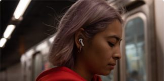 Best Travel Tech Deals: Apple AirPods Pro £40 Off (UK) a woman with purple hair wearing a white earbud and red hoodie
