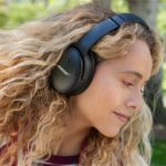 Best Travel Tech Deals: New Bose QC45 Headphones $50 Off a woman wearing headphones
