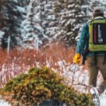 Best Travel Tech Deals: 50% off Uncharted Supply Co. 24Seven Outdoor Survival Kit Bag & More a man carrying a tree