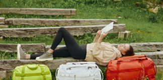 New Away F.A.R Collection Takes you Beyond the Airport Terminal a woman lying on a bench with luggage