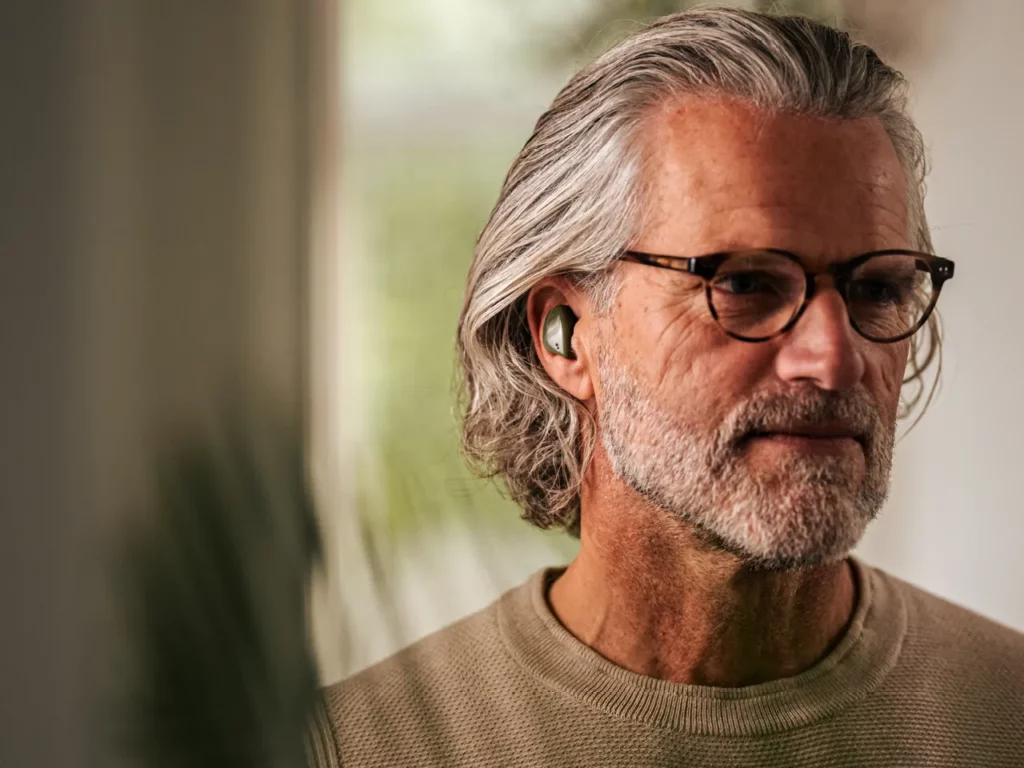 a man wearing glasses and a grey beard. CES 2024 News BREGGZ Earbuds.  {Tech} for Travel. https://techfortravel.co.uk
