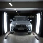 CES 2024: ProovStation to Revolutionise Car Rentals with AI-Powered Scan Inspection a car parked in a garage. ProovStation. CES 2024 news