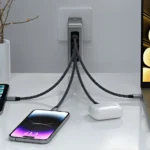 CES 2024: Power Up Anywhere with the Satechi 145W Travel Charger a cell phone charging on a table. Satechi 145W Travel Charger