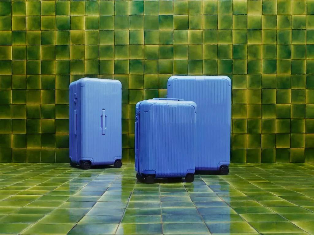 a group of blue suitcases on a tiled floor.  Rimowa Essential Collection in Sea Blue.  {Tech} for Travel.  https://techfortravel.co.uk