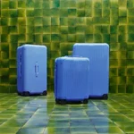 Rimowa Essential Collection Gets a Refresh with Serene Sea Blue a group of blue suitcases on a tiled floor Rimowa Essential Collection