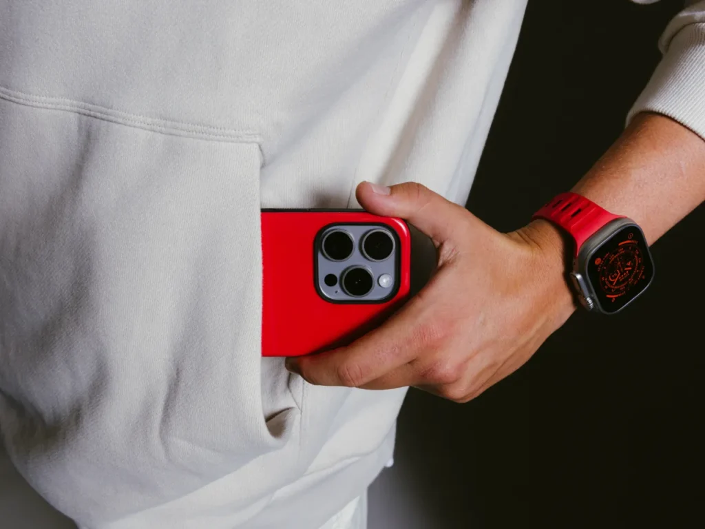 a person holding a red cell phone in their pocket. Limited Edition Nomad Goods.  {Tech} for Travel. https://techfortravel.co.uk