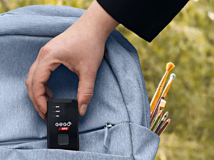 a hand holding a phone in a pocket of a backpack