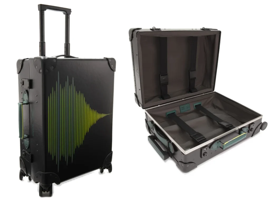 a black suitcase with a green design. Globe Trotter Aston Martin F1 2024 Collection.  {Tech} for Travel. https://techfortravel.co.uk