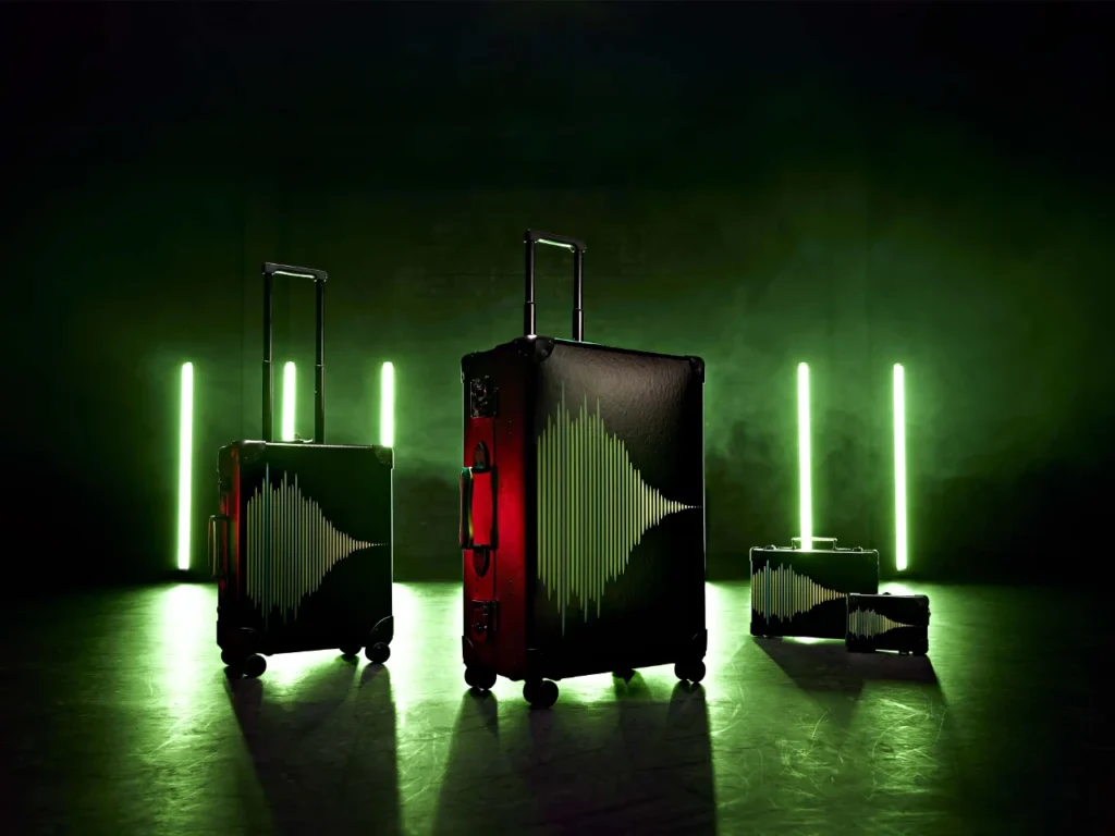 a group of luggage with green lights. Globe Trotter Aston Martin F1 2024 Collection.  {Tech} for Travel. https://techfortravel.co.uk