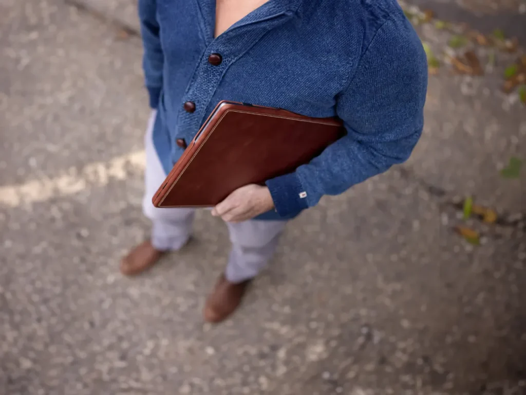 a man holding a brown folder.  Burton Goods Slim Leather MacBook Cover. Father's Day Gifts 2024.  {Tech} for Travel. https://techfortravel.co.uk