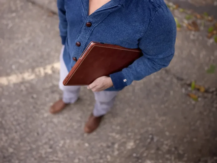 a man holding a brown folder
