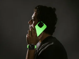 a man holding a phone to his ear. Nomad Goods Glow 2.0
