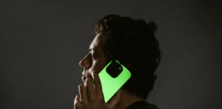 Illuminate Your Gear with the Limited Edition Nomad Goods Glow 2.0 Collection a man holding a phone to his ear. Nomad Goods Glow 2.0