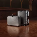 a group of luggage on a wooden floor. RIMOWA Hammerschlag Limited Edition