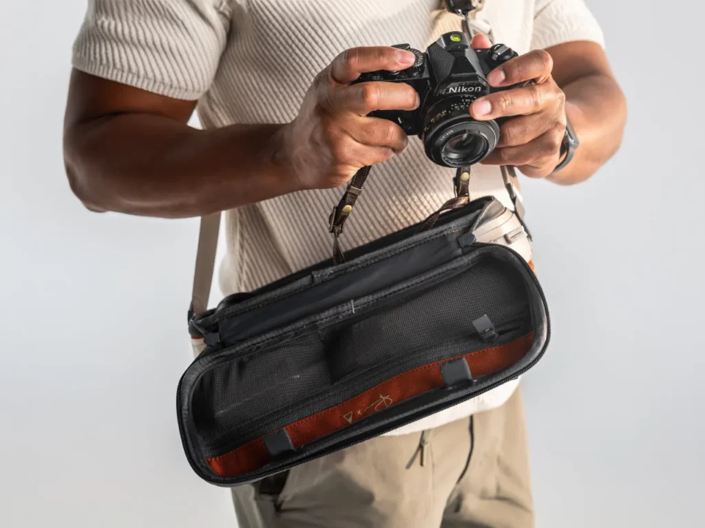 a man holding a camera. Gomatic Luma Camera Sling 9L.  {Tech} for Travel. https://techfortravel.co.uk