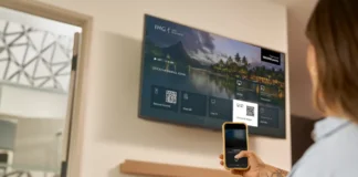 IHG AirPlay Feature Enhances its Guest Experience at Selected North American Hotels a woman sitting on a bed looking at a television screen. IHG AirPlay