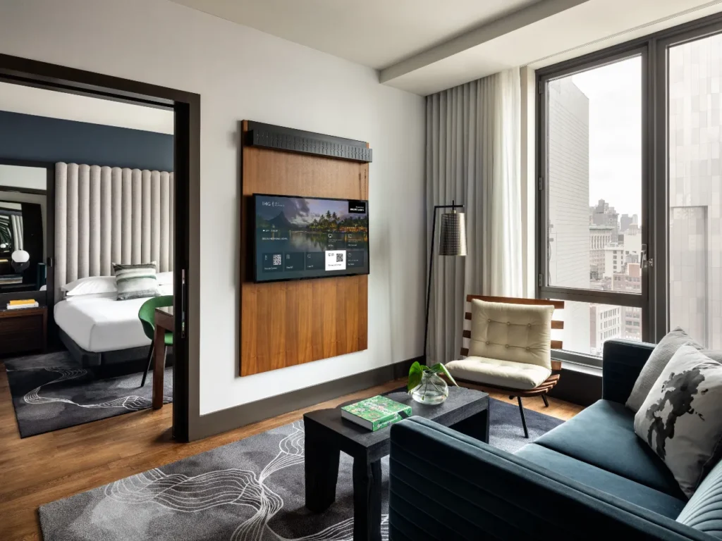 a room with a tv and a couch. IHG AirPlay.  {Tech} for Travel. https://techfortravel.co.uk