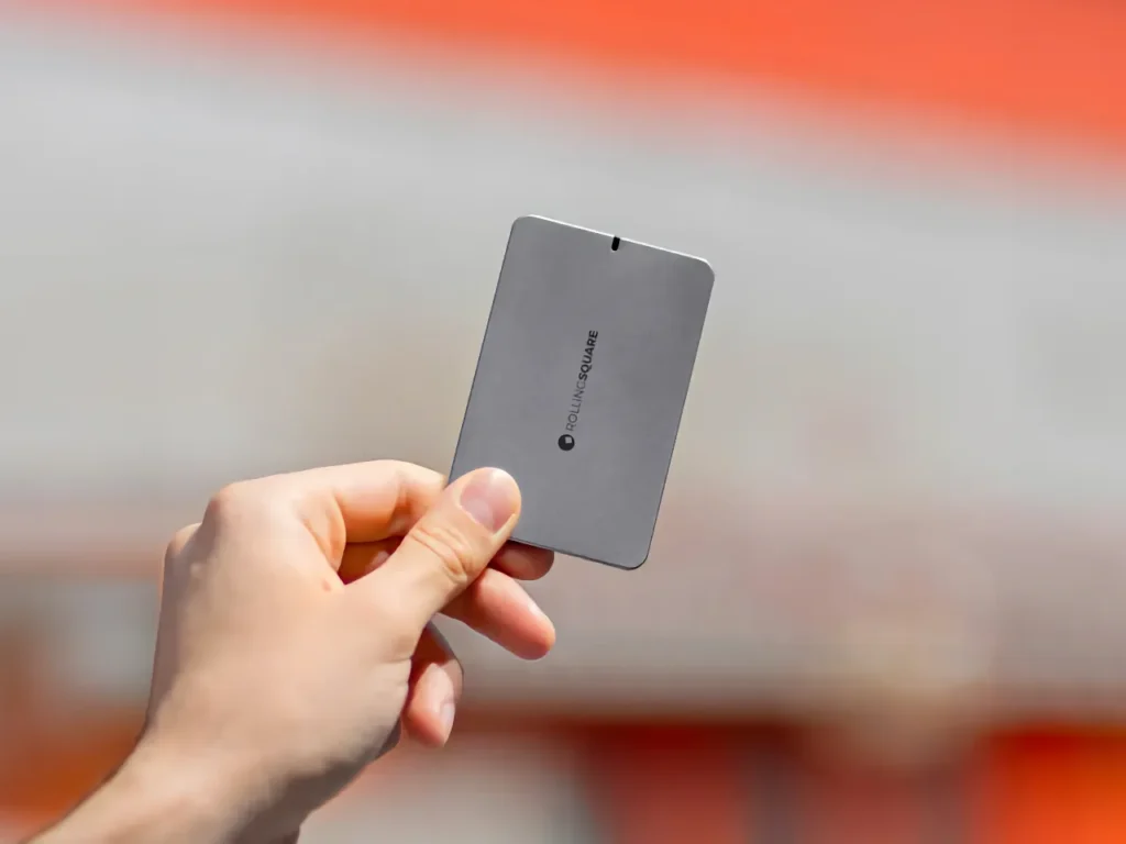 a hand holding a rectangular object. Rolling Square AirCard E.  {Tech} for Travel. https://techfortravel.co.uk