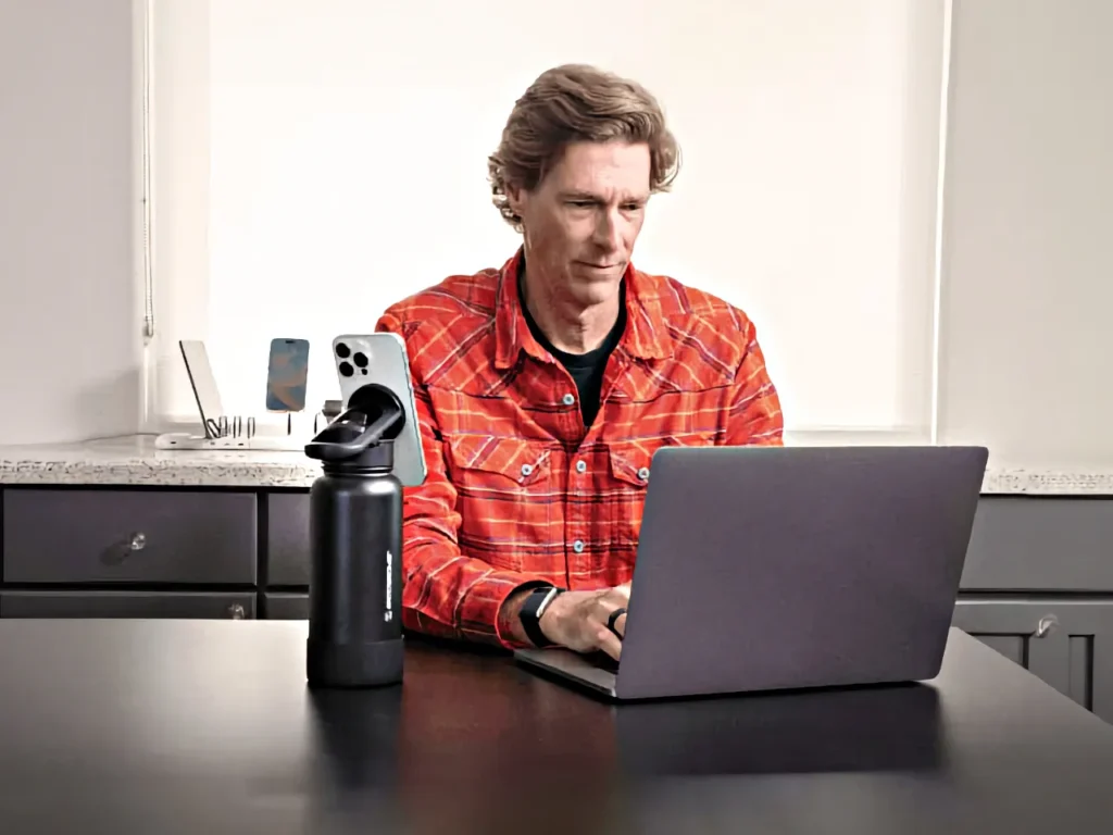 a man sitting at a desk with a laptop. Scosche MagicMount Flask. Father's Day Gifts 2024.  {Tech} for Travel. https://techfortravel.co.uk