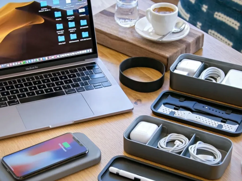 a laptop and cellphone on a table. Best Travel Gadgets 2024. {Tech} for Travel. https://techfortravel.co.uk