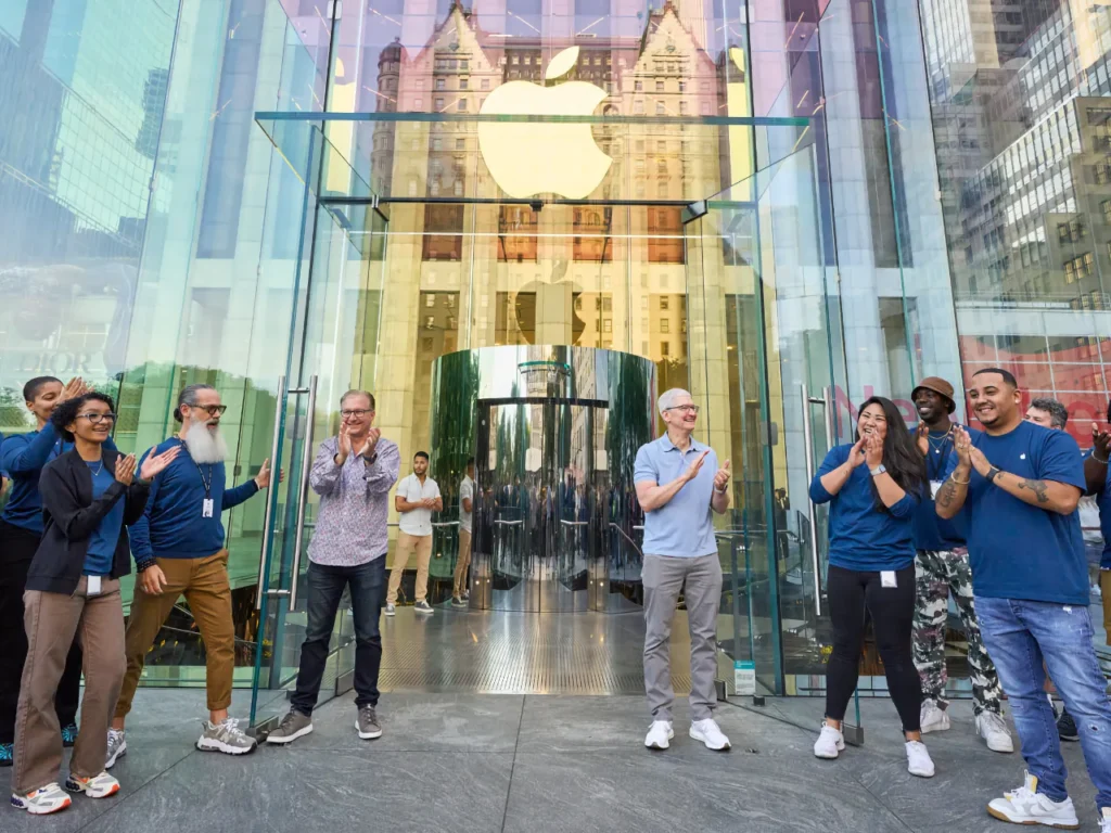 a group of people standing in front of a glass building. Apple New York. Apple iPhone 16 Event. {Tech} for Travel. https://techfortravel.co.uk