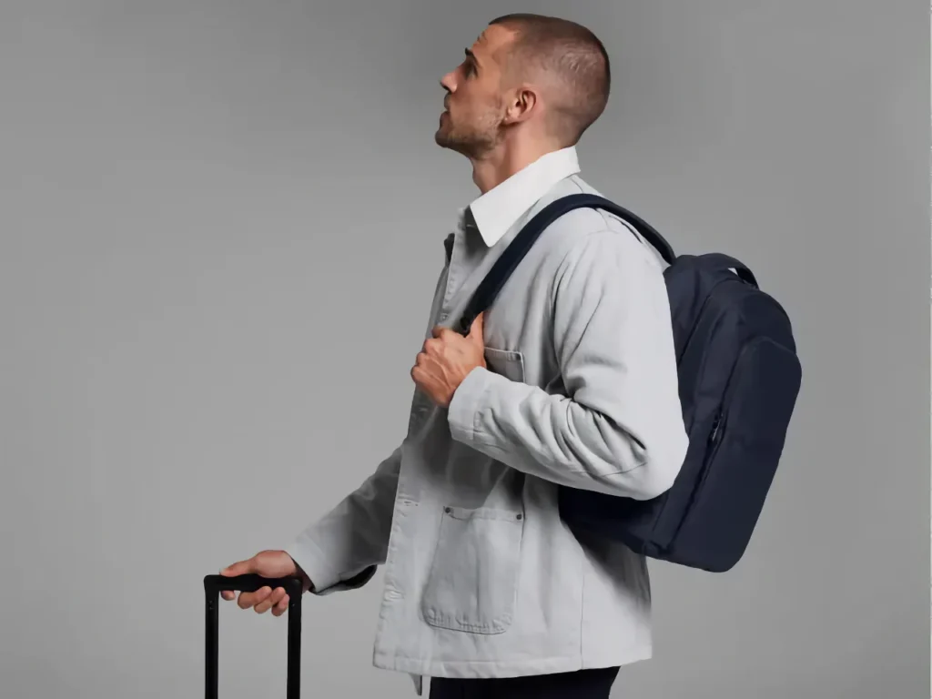 a man carrying a backpack. Away Commuter Backpack. {Tech} for Travel. https://techfortravel.co.uk